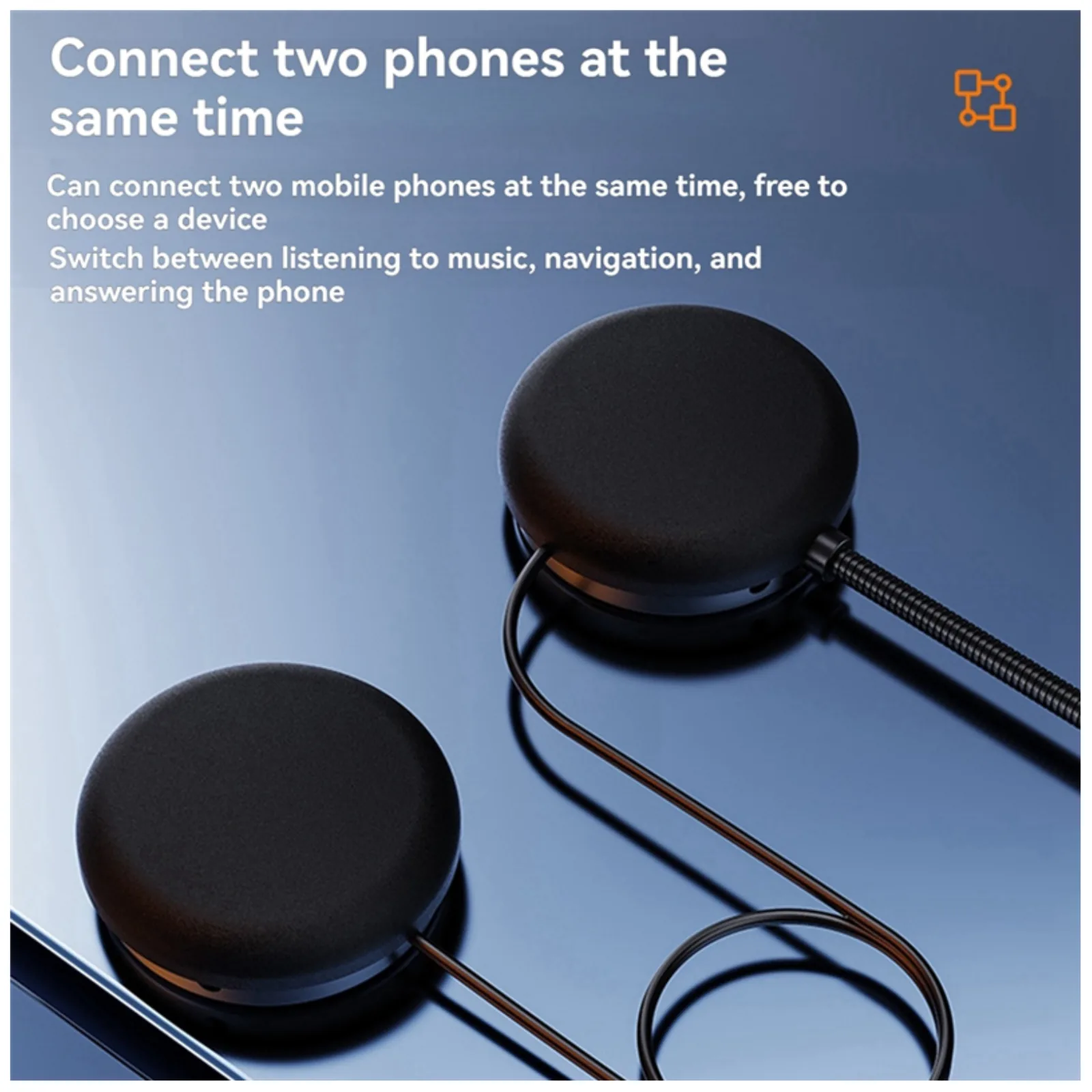 Two round Bluetooth BTX speakers on a dark surface with text about connecting two phones at the same time